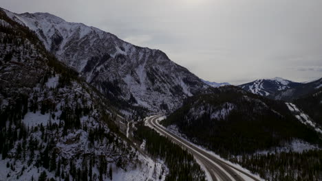 Distant-i70-Copper-Mountain-Colorado-Winter-December-Christmas-aerial-drone-cinematic-landscape-Leadville-Silverthorne-Vail-Aspen-Ten-Mile-Range-cloudy-Rocky-Mountains-upward-reveal
