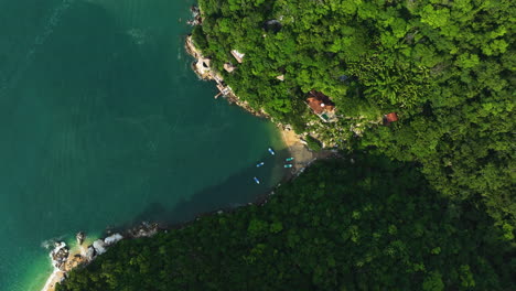 Aerial-top-down-shot-rising-above-boats-at-the-Colomitos-Beach,-in-sunny-Mexico