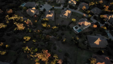 Suburban-homes-at-sunset,-aerial-shot,-forward-dolly