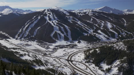 Copper-Mountain-Colorado-Winter-December-Christmas-aerial-drone-cinematic-landscape-i70-Leadville-Silverthorne-Vail-Aspen-Ten-Mile-Range-blue-sky-clouds-backwards-past-Rocky-Mountains-motion