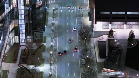 Aerial-tilt-up-shot-of-cars-on-multi-lane-road-in-Atlanta-City-at-night-and-Skyscraper-Buildings-in-background