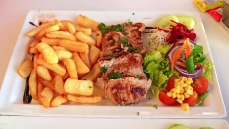Balanced-Meal-with-Meat,-Potatoes,-and-Colorful-Vegetables:-Grilled-Pork-Tenderloin-with-Golden-Fries-and-Fresh-Salad
