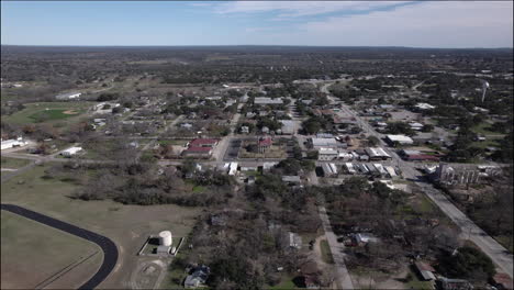 Aerial-Shot-over-Johnson-City,-Texas-and-Hill-Country,-dolly-forwards-to-historic-courthouse-and-downtown