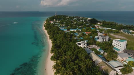 A-Smooth-Aerial-Shot-Of-A-Small-Island-Surrounded-With-Palm-Trees-And-The-White-Beach