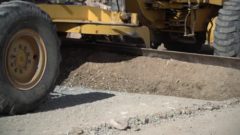 Construction-machinery-clearing-and-smoothing-out-a-gravel-road