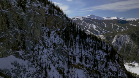 Copper-Mountain-Colorado-Winter-December-Christmas-aerial-drone-cinematic-landscape-i70-Leadville-Silverthorne-Vail-Aspen-Ten-Mile-Range-blue-sky-clouds-reveal-past-Rocky-Mountains-forward-motion