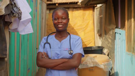 African-female-nurse-doctor-with-stethoscope-laughing-smiling-and-crossed-arms-in-front-of-camera-in-clinic-hospital-of-Africa
