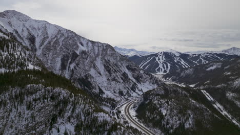 Distant-i70-Copper-Mountain-Leadville-Colorado-Winter-December-Christmas-aerial-drone-cinematic-landscape-Silverthorne-Vail-Aspen-Ten-Mile-Range-cloudy-Rocky-Mountains-upward-reveal-forward-motion