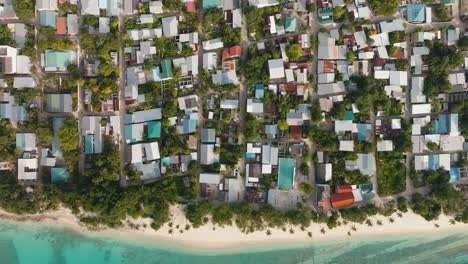 An-Aerial-Shot-Of-A-Tight-Coastal-Village-With-Calm-Surroundings-And-The-Turquoise-Sea