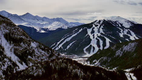 Distant-i70-Copper-Mountain-Leadville-Colorado-Winter-December-Christmas-aerial-drone-cinematic-landscape-Silverthorne-Vail-Aspen-Ten-Mile-Range-cloudy-Rocky-Mountains-upward-reveal