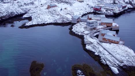 Serene-picturesque-village-unveiled-with-blanket-of-snow-and-sea-water