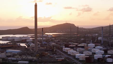 Golden-hour-glow-cast-on-oil-refinery-stacks-in-Willemstad-Curacao-at-sunset