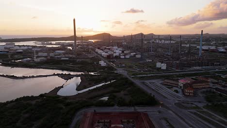 Panoramic-aerial-establishing-overview-of-oil-refinery-stacks-at-sunset