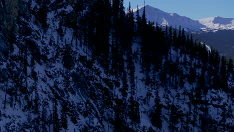 Ski-runs-trails-Copper-Mountain-Colorado-Winter-December-Christmas-aerial-drone-cinematic-landscape-i70-Leadville-Silverthorne-Vail-Aspen-Ten-Mile-Range-blue-sky-clouds-reveal-over-Rocky-Mountains