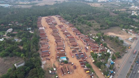 An-aerial-video-showing-a-container-warehouse-and-truck-yard-in-the-middle-of-the-highway