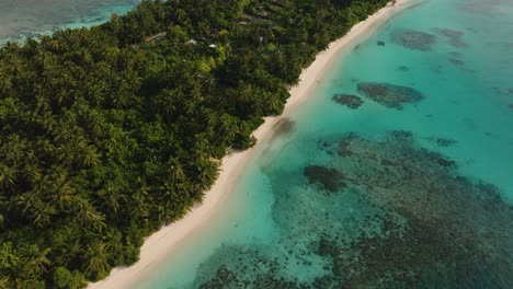An-Aerial-Shot-Of-A-Small-Rustic-Island-With-A-Tropical-Forest-And-Turquoise-Sea-Water