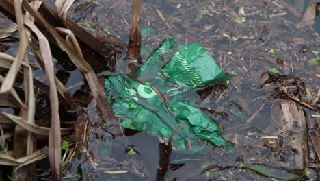 Polythene-bag-on-surface-of-pond.-UK