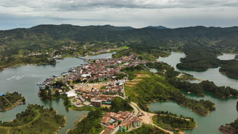 Luftaufnahme-In-Richtung-Der-Stadt-Guatape,-Teilweise-Sonniger-Tag-In-Antioquia,-Kolumbien