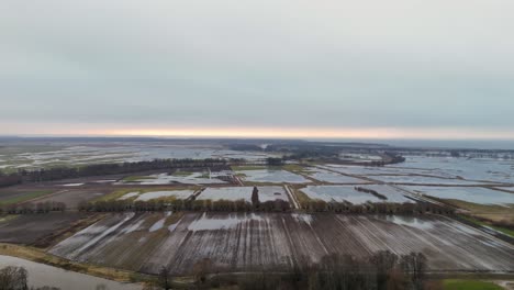 Aerial-establishing-shot-of-flooded-fields-during-autumn-rain-season