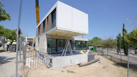 Heavy-crane-and-modular-home-construction-site-motion-view