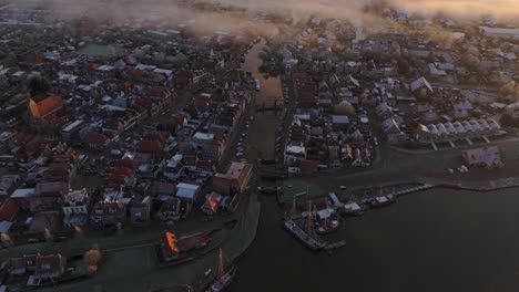 Makkum-town-Friesland-during-a-foggy-winter-morning,-aerial