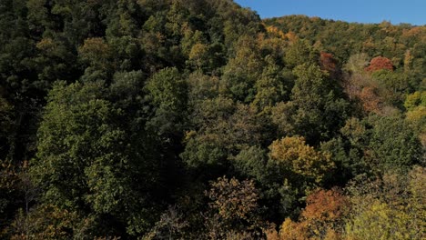 Autumn-mountain-scene-in-Arbúcies,-Girona,-aerial-drone-traveling