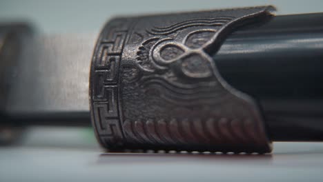 A-macro-shot-of-two-ancient-silver-knifes-opening,-Chinese-antique-weapon,-historical-vintage-blade,-old-textured-steel,-traditional-dagger,-professional-lighting,-cinematic-slow-motion-120-fps