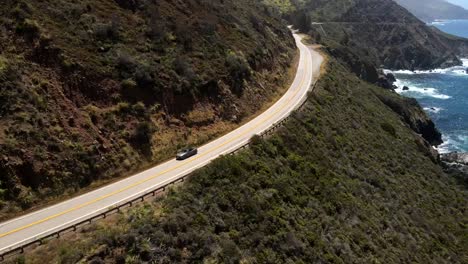 Cinematic-aerial-drone-shots-capturing-a-silver-gray-Ford-Mustang-as-it-journeys-into-the-highway-amidst-the-Valley