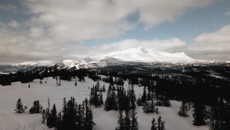 Snowy-Mountains-in-the-distance,-drone-shot