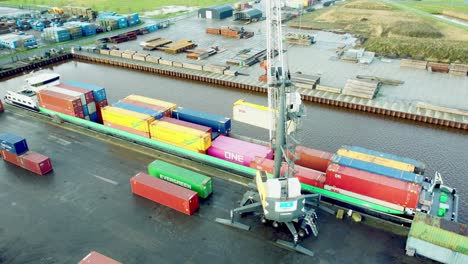 Loading-sea-containers-on-a-ship-with-a-crane-topdown-view