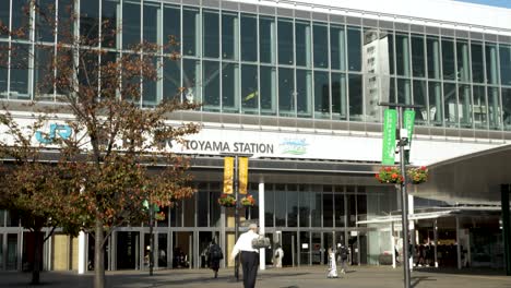 People-walk-around-the-entrance-to-Toyama-train-station-in-Japan