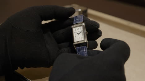 Expensive-wristwatch-in-hands-of-professional-with-black-gloves