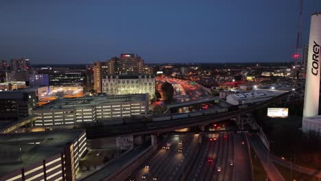 Drone-shot-of-Atlanta-city-road-traffic-in-the-evening,-Corey-Tower-and-Grady-hospital-building-in-view