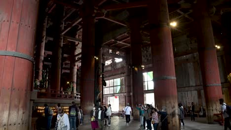 Touristen,-Die-Den-Todaiji-Tempel-Bewundern,-Machen-Fotos-Zwischen-Den-Großen-Säulen-Der-Architektur-Im-Inneren-Des-Heiligtums