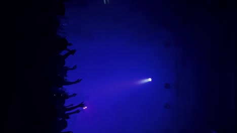 Vertical-handheld-medium-shot-of-Samuel-Holden-Jaffe-and-members-performing-live-in-concert-as-the-Del-Water-Gap-band-with-purple-flashing-stage-lighting-at-the-Complex-in-Salt-Lake-City-Utah