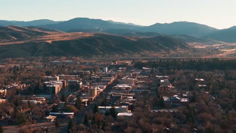 Static-drone-shot-viewing-downtown-Bozeman,-Montana-at-sunrise-in-the-fall