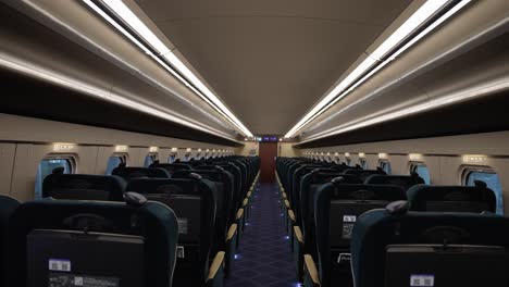 Inside-View-Of-Empty-Green-Car-Class-Hokuriku-Shinkansen-Bullet-Train-From-The-Aisle