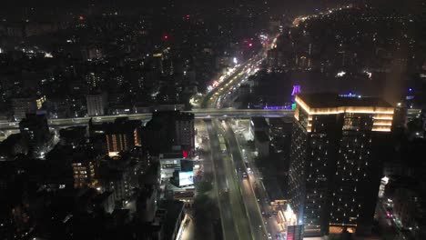 Rajkot-aerial-drone-view-drone-is-moving-towards-where-many-vehicles-are-passing-over-the-bridge-and-high-rise-buildings-are-visible-around
