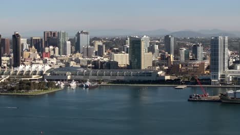 Drone-Rising-Above-Urban-San-Diego-downtown-Skyline-Waterfront,-4K-Resolution-USA