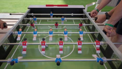 foosball-competition-between-young-men-in-the-hall-insert-shot,-Close-up-shot