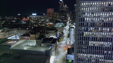 Luftflug-Entlang-Eines-Modernen-Geschäftsgebäudes-Und-Der-Beleuchteten-Skyline-Der-Stadt-Atlanta-Bei-Nacht-–-Aufnahme-Einer-Drohnenaufnahme-Der-Modernen-Stadt