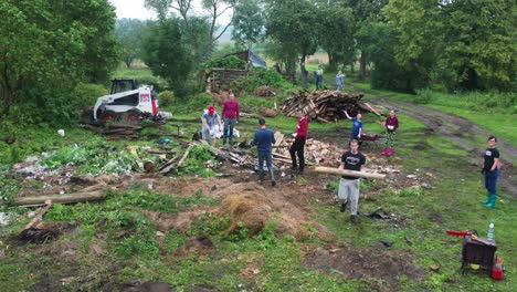 Family-gathering-at-countryside-to-dismantle-and-clean-yard-from-old-buildings