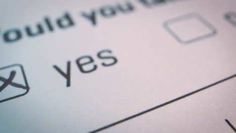 Slow-motion-close-up-over-the-checked-YES-box-on-official-form-white-document,-voting,-decisions,-choices-of-yes-or-no-checkbox