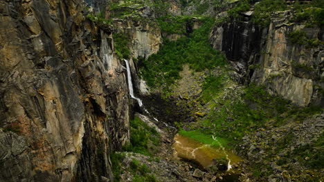 Geological-formation-featuring-steep-walls-of-limestone-rock-and-water