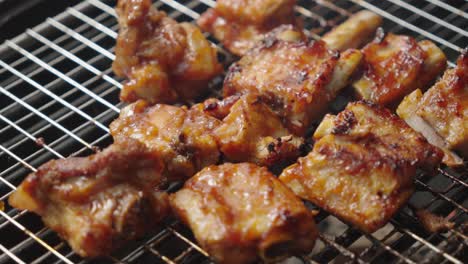 Chef's-hands-brushing-pork-ribs-with-butter-on-the-grill,-close-up-shot