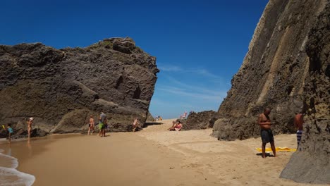 Tourists-holidays-on-a-sandy-beach-called-Praia-Grande-de-Porto-Covo,-Sines,-Vicentina-Route,-Portugal