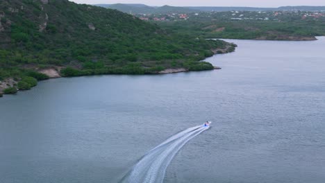 Aerial-rear-view-follows-boat-entering-Piscadera-Harbor-Willemstad-Curacao