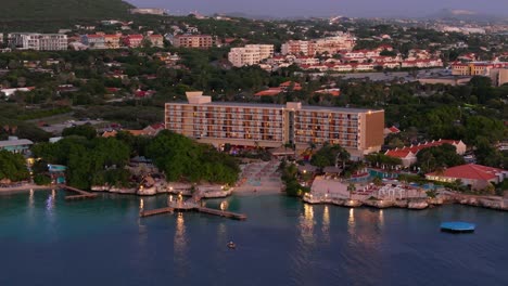 Wide-angle-aerial-orbit-around-exclusive-hotel-and-private-beach-in-Caribbean-at-dusk