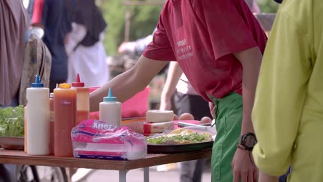 Street-food-seller-is-making-sandwich-on-the-table-for-customers