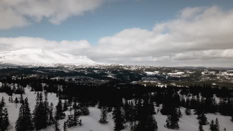 Snowy-mountains-in-the-distance,-drone-shot,-crane-shot